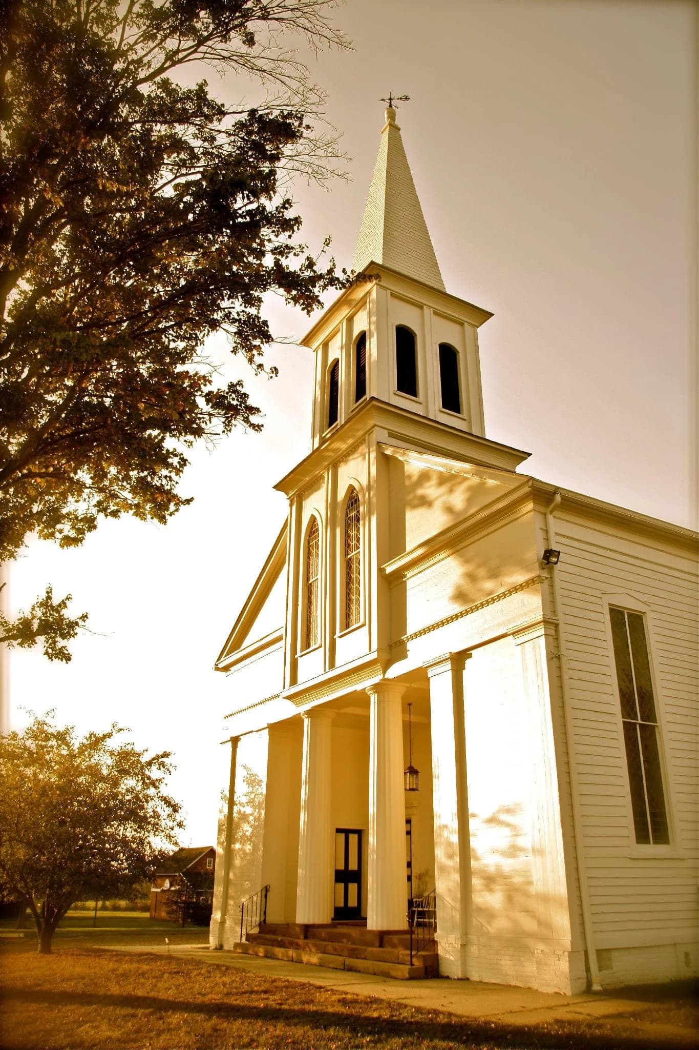 Sunlight on the white columns and historic steeple of Lamington Presbyterian Church