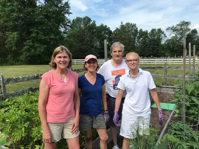 Lamington Giving Garden volunteers standing together by the raised beds